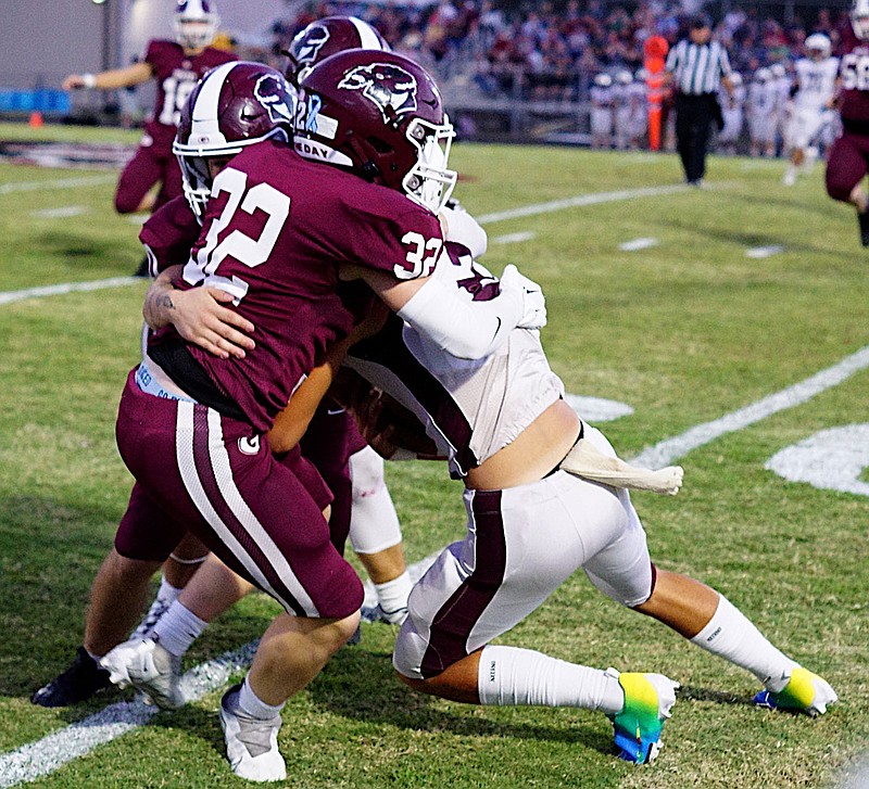 Westside Eagle Observer/RANDY MOLL
Jared James and two other Pioneers put a stop to a run by the Huntsville quarterback during play in Pioneer Stadium on Friday night.