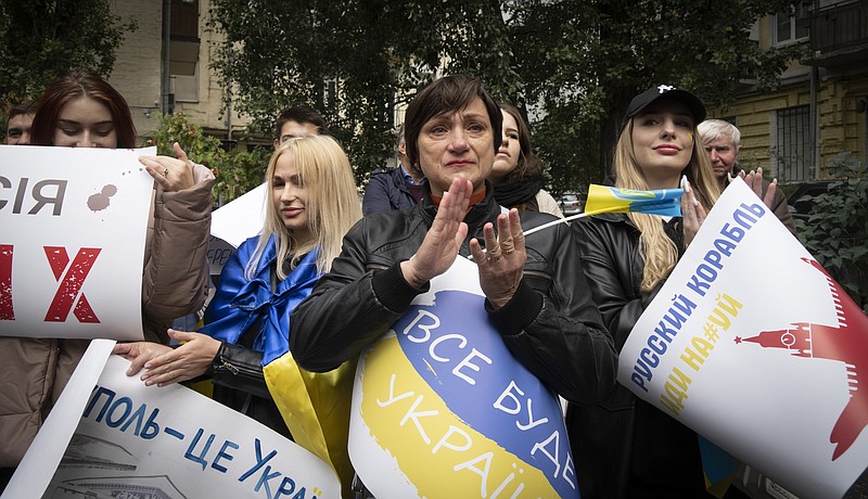 Residents of Mariupol hold a rally against a Kremlin-orchestrated referendum in Kyiv, Ukraine, Saturday, Sept. 24, 2022. Banner reads: "Mariupol is Ukraine". Voting began Friday in four Moscow-held regions of Ukraine on referendums to become part of Russia. (AP Photo/Efrem Lukatsky)