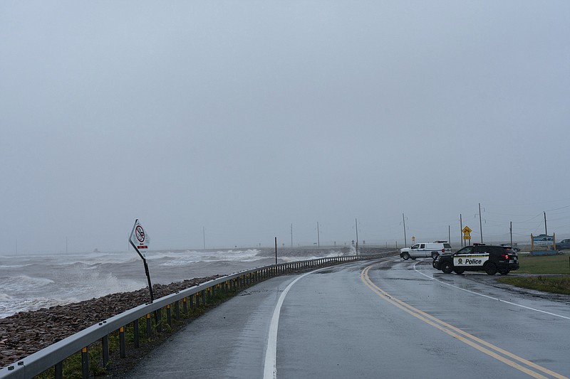 A police roadblock along Havre-aux-Basques linking Cap-aux-Meules to Havre-Aubert post-tropical storm Fiona is shown on the Les Îles-de-la-Madeleine, Que., Saturday, Sept. 24, 2022. Strong rain and winds are lashing the Atlantic Canada region as Fiona hits as a powerful post-tropical cyclone. (Nigel Quinn /The Canadian Press via AP)
