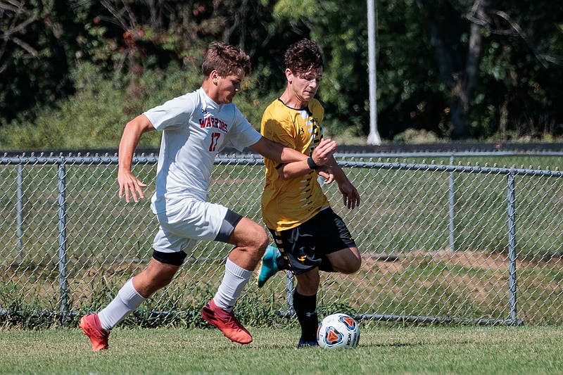 Fulton boys soccer forward Jayden Ayers dribbles Warrenton defender Maison Rader Saturday at Fulton's soccer field in Fulton. (Courtesy/Shawley Photography)