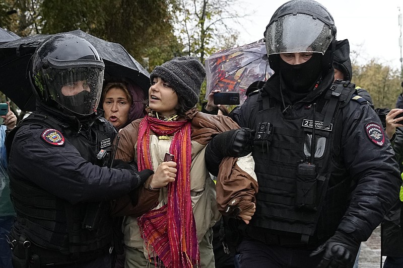 Police officers detain a demonstrator during a protest against a partial mobilization in Moscow, Russia, Saturday, Sept. 24, 2022. (AP Photo)