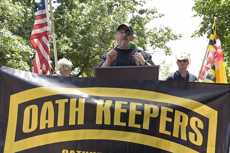 FILE - Stewart Rhodes, founder of the Oath Keepers, center, speaks during a rally outside the White House in Washington, June 25, 2017. Hundreds of pages of court documents in the case against Rhodes and four co-defendants, whose trial opens with jury selection Tuesday, Sept. 27, 2022, in Washington's federal court, paint a picture of a group so determined to overturn Biden's election that some members were prepared to lose their lives to do so. (AP Photo/Susan Walsh, File)