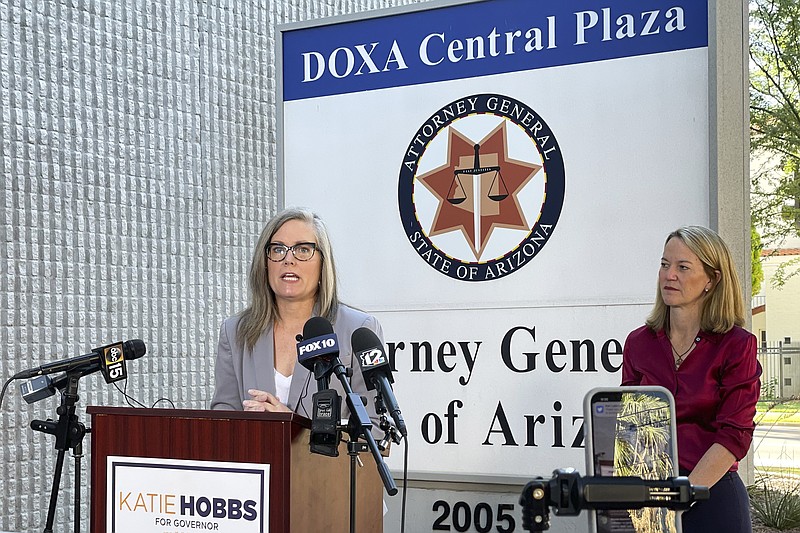 Arizona Secretary of State Latie Hobbs, left, the Democratic nominee for governor, and Kris Mayes, a Democrat running for attorney general, speak to reporters outside the Arizona Attorney General's Office in Phoenix on Saturday, Sept. 24, 2022. (AP Photo/Jonathan J. Cooper)