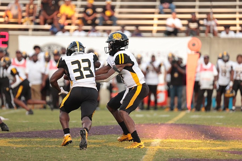 Golden Lions quarterback Skyler Perry (right) hands the ball to Kayvon Britten during first-half action Saturday night against Alcorn State University at Lorman, Miss. (Special to The Commercial/Alcorn State University)