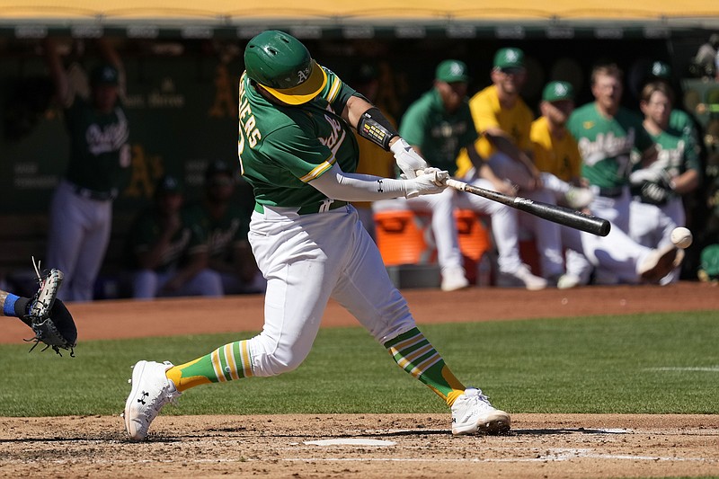 Oakland Athletics' Shea Langeliers hits a double to drive in a run against the New York Mets during the first inning of a baseball game in Oakland, Calif., Saturday, Sept. 24, 2022. (AP Photo/Tony Avelar)
