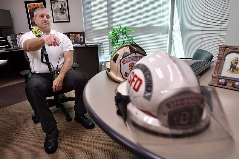 Springdale Fire Chief Blake Holte gestures Tuesday, Sept. 20, 2022, while speaking about the two styles of firefighting helmets available to firefighters. The department has decided to change to from the metro style helmet to a more traditional style favored by current staff. The department will purchase about 160 of them in different colors to signify different roles in the department to further aid quick identification of staff during an emergency. Visit nwaonline.com/220925Daily/ for today's photo gallery. 
(NWA Democrat-Gazette/Andy Shupe)
