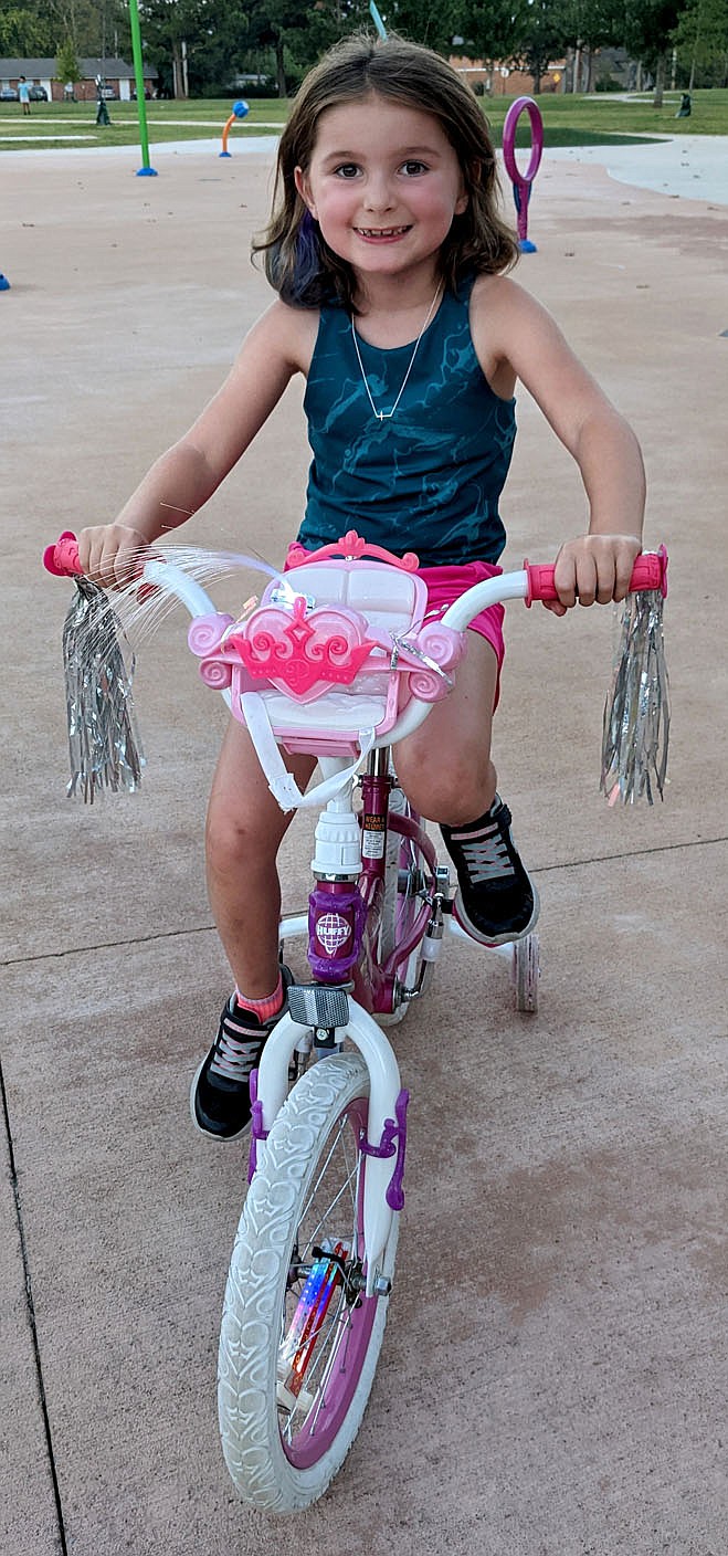 Westside Eagle Observer/RANDY MOLL
Emery Schortzmann, 6, arrived ready to decorate her bike with glow sticks and ride in Gentry's annual Glow Ride on Saturday.