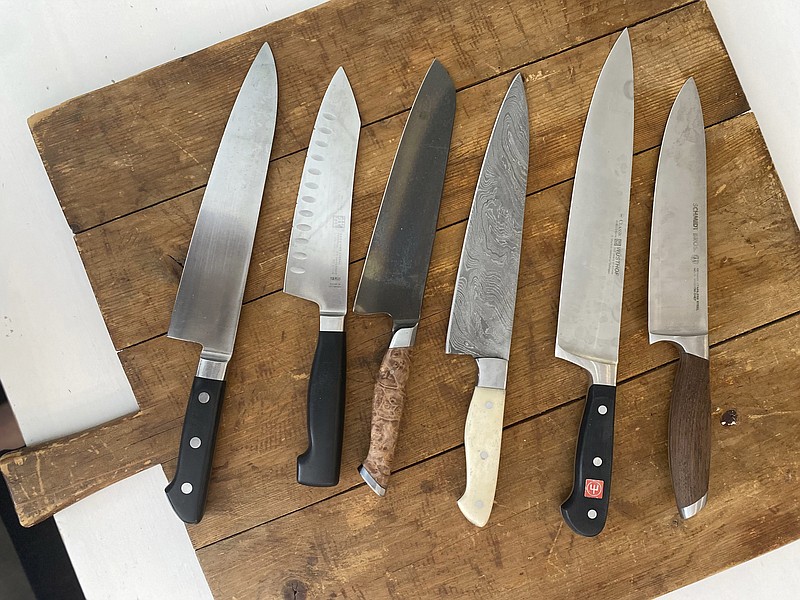 This July 2022 image shows a variety of kitchen knives. Many professionals will say you can perform virtually any kitchen task skillfully with either a chef&#x2019;s knife or a paring knife. Adding other knives to your arsenal is appealing and can be useful but isn't strictly necessary. (Katie Workman via AP)