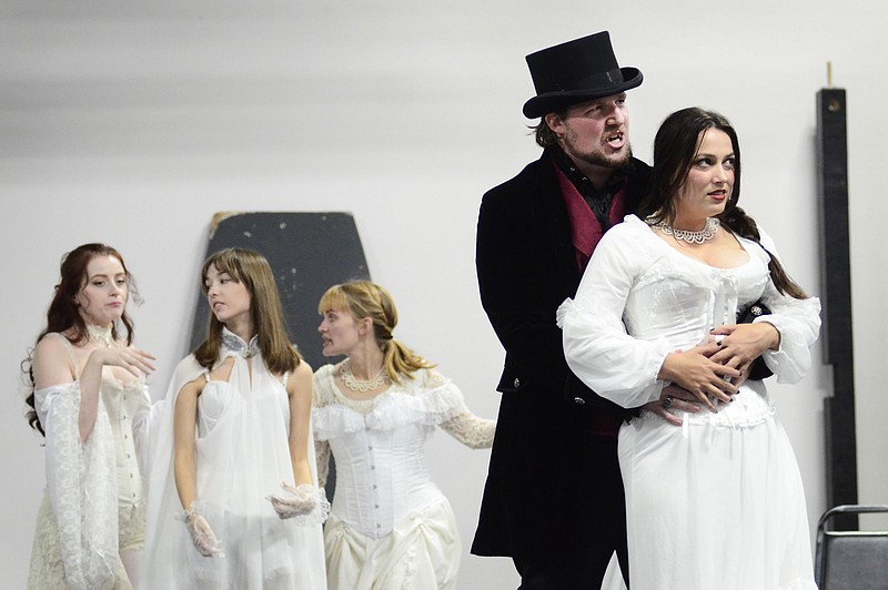 Eileen Wisniowicz/News Tribune photo: 
Dracula played by Adam Shields holds Lucy played by Ashton Knippenberg on Tuesday, Oct. 4, 2022 during a Dracula rehearsal in Jefferson City. Dracula's other brides dance in the background.
