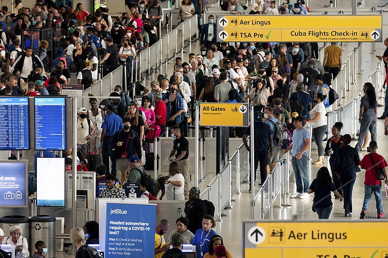 FILE - People wait in a TSA line at the John F. Kennedy International Airport in New York, Tuesday, June 28, 2022. With summer vacations winding down, airlines are counting on the return of more business travelers to keep their pandemic recovery going into fall 2022. Air travel in the United States, bolstered by huge numbers of tourists, has nearly recovered to pre-pandemic levels. Business travel, however, remains about 25% to 30% below 2019 levels, according to airlines and outfits that track sales. (AP Photo/Julia Nikhinson, File)