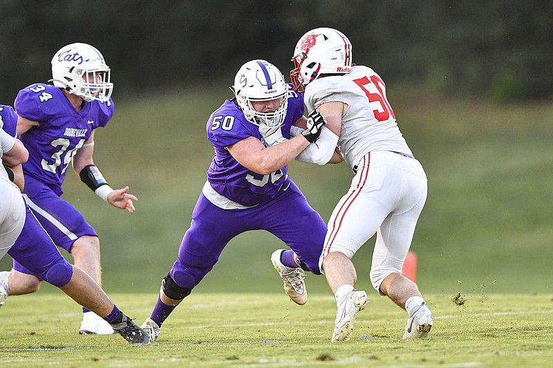 Johnny Barnes, center, of Booneville blocks a Harding Academy defender on Friday, Sept. 16, 2022. Barnes moved to Booneville from a neighboring town and quickly learned the culture in the Bearcats' program is far different from other football teams. 
(NWA Democrat-Gazette/Hank Layton)