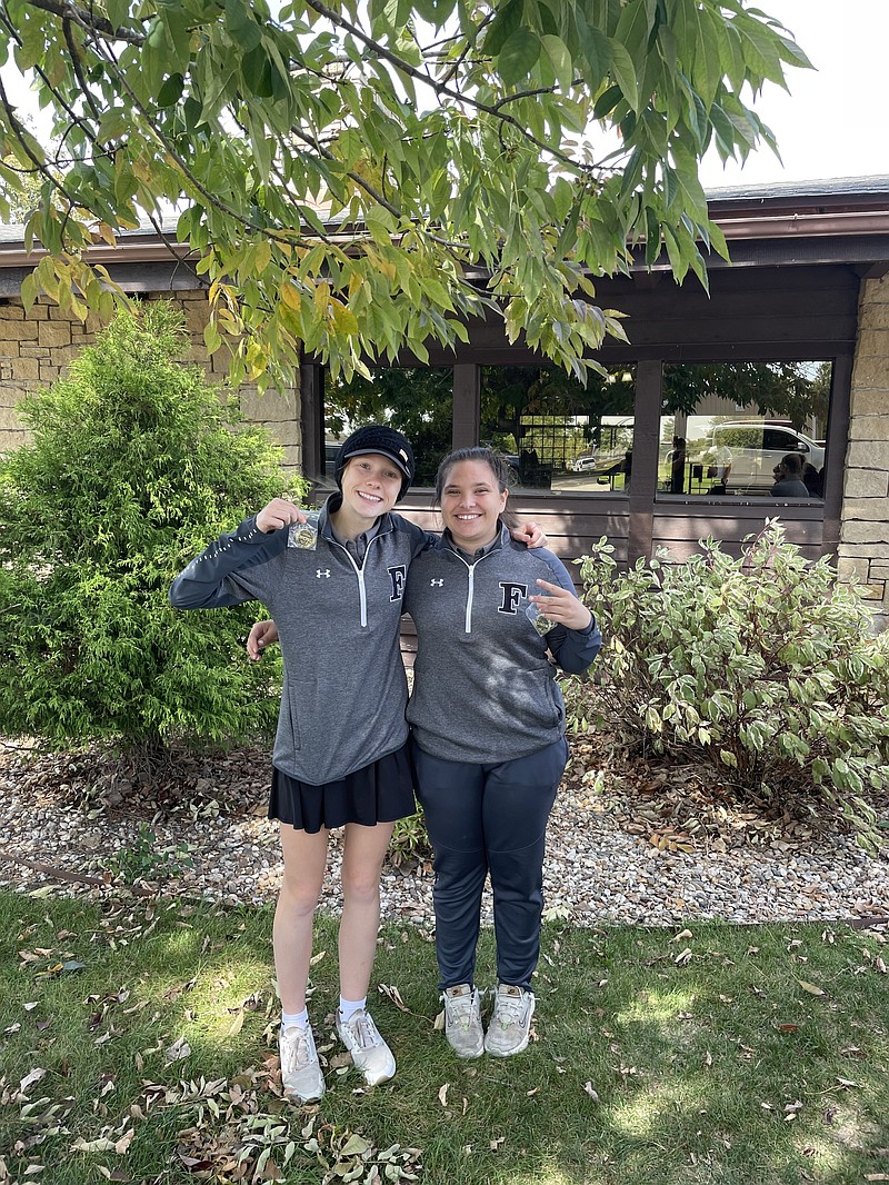 Fulton girls golf medalist Grace Ousley (left) and Carly Foster (right) pose for a picture with their conference tournament medals. (Contributed Photo)