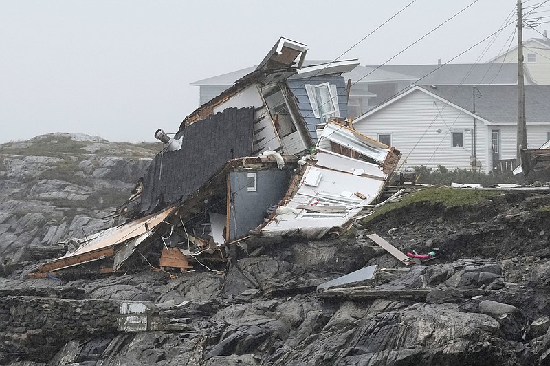 Remains of a home destroyed during Hurricane Fiona are seen in Port aux Basques, Newfoundland and Labrador, Monday, Sept. 26, 2022. Across the Maritimes, eastern Quebec and in southwestern Newfoundland, the economic impact of hurricane Fiona's wrath is still being tallied. (Frank Gunn/The Canadian Press via AP)
