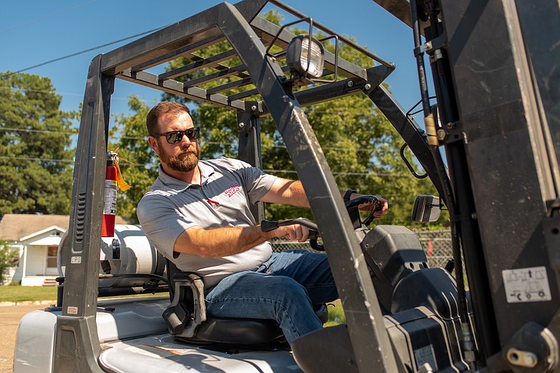 Russell Sparks, president of Hightech Signs and president of Oaklawn Rotary Club, operates heavy machinery while on the job Friday, Sept. 23, 2022, in Texarkana, Texas.  (Staff photo by Erin DeBlanc)