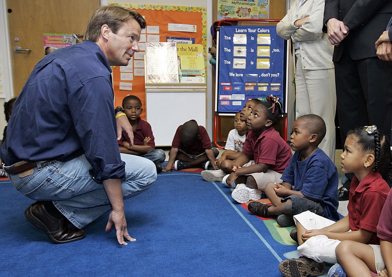 FILE - Presidential hopeful, former North Carolina Sen. John Edwards, left, talks to children in a head start class during a campaign stop at Kingsley House in New Orleans on July 16, 2007. The social services nonprofit, may be best known as the Kingsley House, has dropped the name of a Victorian clergyman Tuesday, Sept. 27, 2022, who is best remembered today as the author of a children's fantasy novel but held profoundly racist views. (AP Photo/Alex Brandon, File)