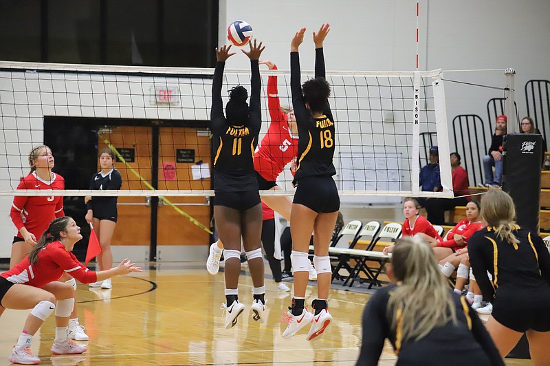 Fulton's Quiara Walton (11) and Arianna Conner (18) attempting to block Hannibal's hit Tuesday in Fulton. (Courtesy/Danuser Photography)