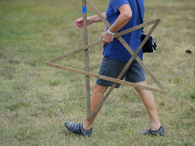 A shopper carries a wooden star Saturday, Oct. 2, 2021, while searching for items at the fall show at Junk Ranch in Prairie Grove. Visit nwaonline.com/211003Daily/ for today's photo gallery.
(NWA Democrat-Gazette/Andy Shupe)