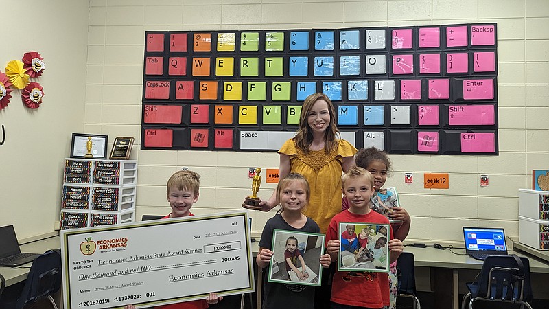 Jessica Talley poses with students and awards in her classroom. (Joshua Turner / Banner News)