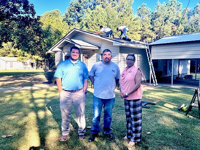 Pictured at the home are Habitat Board Vice Chair Adam Tinsley; construction manager Robert Ortegon, of Free Lighting Corporation; and Habitat Board Chair Jennifer Hamilton. (Contributed)