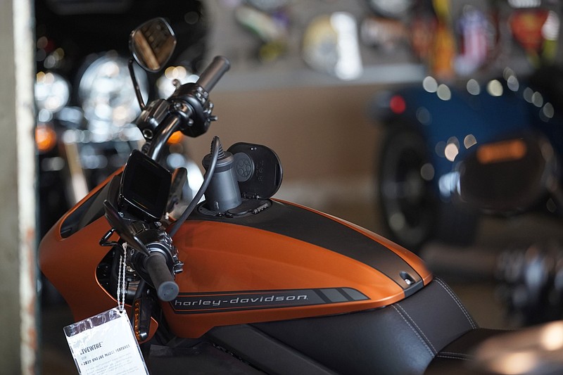 A charger is plugged into a LiveWire electric motorcycle at a Harley-Davidson showroom and repair shop in Lindon, Utah, on April 19, 2021. MUST CREDIT: Bloomberg photo by George Frey