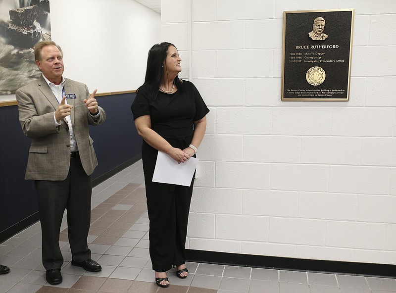 Heather Rutherford looks at a plaque honoring her late husband, former Benton County Judge Bruce Rutherford, on Thursday in the lobby of the County Administration Building in Bentonville. Benton County justices of the peace last month approved a resolution 15-0 to dedicate the Benton County Administration Building in honor of the former county judge. Visit nwaonline.com/220930Daily/ for today’s photo gallery.

(NWA Democrat-Gazette/Charlie Kaijo)