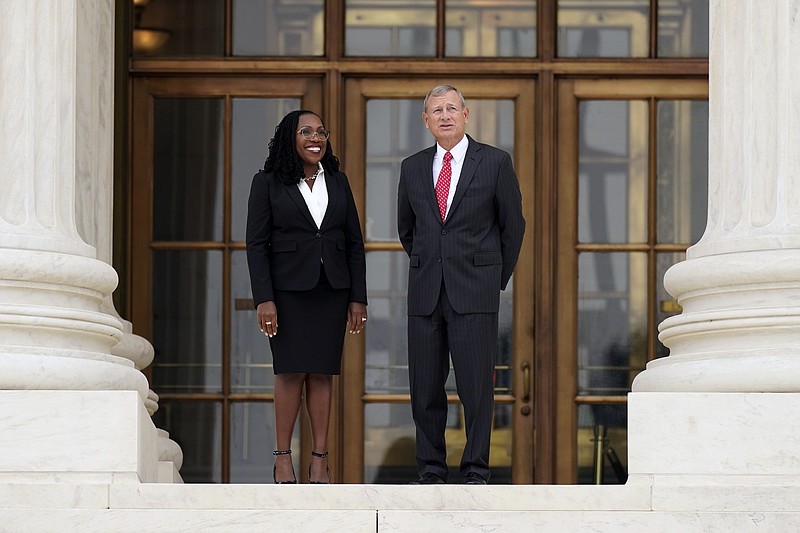 Supreme Court Associate Justice Ketanji Brown Jackson stands outside the Supreme Court with Chief Justice of the United States John Roberts, following her formal investiture ceremony at the Supreme Court in Washington, Friday, Sept. 30, 2022. (AP Photo/Carolyn Kaster)