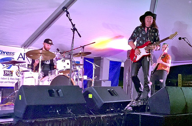 Anthony Gomes, center, plays during the Big Steam Music Festival on Sept. 23 with Chris Whited on drums and Jacob Mren on bass. - Photo by James Leigh of The Sentinel-Record