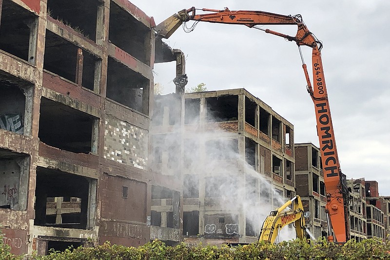 A demolition claw begins razing part of the long-vacant Packard auto plant on Thursday, Sept. 29, 2022, in Detroit. (AP Photos/Corey Williams)