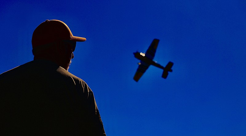 Patrick Mason of Paradise, Texas, flies his heavy metal, giant-scale Extreme Flight Max plane Saturday morning during Texarkana Radio Control Flying Club’s Fly-In event at Ravel Stroman Field at Lake Wright Patman, 10 miles southwest of Texarkana, Texas. Mason has been flying radio-controlled planes for more than 30 years. The Fly-In lasts through today. There is a concession stand and Toys for Tots donations are being accepted. For more information, call Clay Mitchell at 903-826-3615 or Corey Ashley at 903-293-8351. The TRCFC website is trcfc.org. (Photo by JD)
