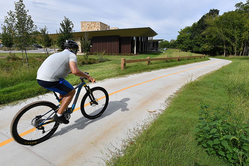 A cyclist rides Sept. 1 along the Spring Creek Trail at the Arkansas Game and Fish Commission's J.B. and Johnell Hunt Ozark Highland Family Nature Center in Springdale. 
(File Photo/NWA Democrat-Gazette/Andy Shupe)