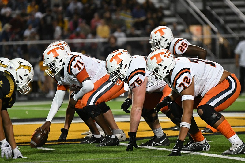 Photo by Kevin Sutton
Texas High offensive linemen (left to right) Richard Jackson (71), John Jack (72) and Briley Barron (76) prepare for the snap while Joe Miller (25) awaits in the backfield Friday night at Sam Parker Field in Mount Pleasant.