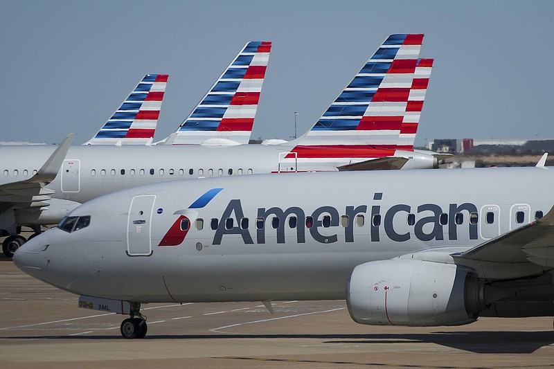 American Airlines planes are seen at the gates of Terminal C at Dallas/Fort Worth International Airport on Saturday, Oct. 16, 2021. In 2019, the FAA approached American Airlines and told the airline it had been using only about 200 of the 216 slots it had been assigned at the time. (Smiley N. Pool/The Dallas Morning News/TNS)