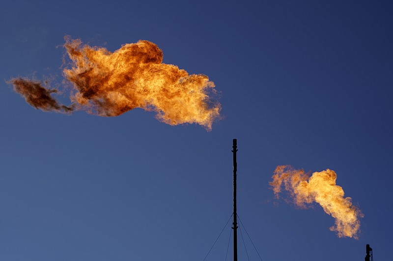 FILE - Flares burn off methane and other hydrocarbons at an oil and gas facility in Lenorah, Texas, Friday, Oct. 15, 2021. Climate scientists have found that methane emissions from the oil and gas industry are far worse than what companies are reporting, despite claims by some major firms that they’ve reduced their emissions. (AP Photo/David Goldman, File)