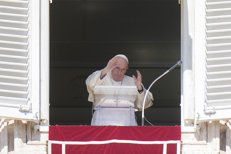 Pope Francis waves during the Angelus noon prayer from the window of his studio overlooking St. Peter's Square on Sunday, Oct. 2, 2022, at the Vatican. The pontiff has appealed to Russian President Vladimir Putin, imploring him to "stop this spiral of violence and death" in Ukraine. Francis also called on Ukrainian President Volodymyr Zelenskyy to "be open" to serious peace proposals. (AP Photo/Alessandra Tarantino)