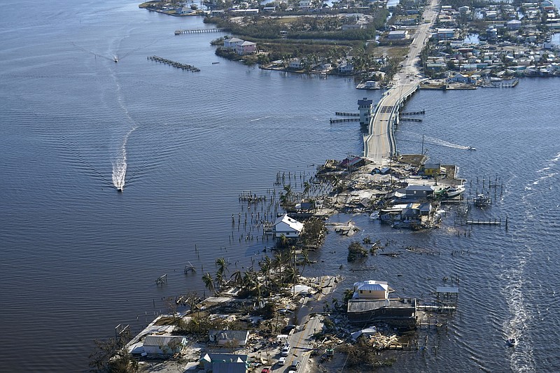 The bridge leading from Fort Myers to Pine Island, Fla., is heavily damaged in the aftermath of Hurricane Ian, Saturday, Oct. 1, 2022. Due to the damage, the island can only be reached by boat or air. (AP Photo/Gerald Herbert)