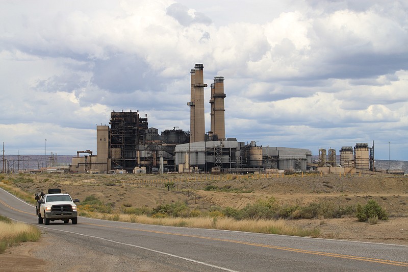 A work truck leaves the San Juan Generating Station near Waterflow, New Mexico, on Tuesday, Sept. 20, 2022. The coal-fired power plant's single operating unit burned the last bit of coal before the end of September. Public Service Co. of New Mexico executives told state regulators during a recent meeting that they are still searching for options to replace some of the lost capacity for next summer's peak season. (AP Photo/Susan Montoya Bryan)