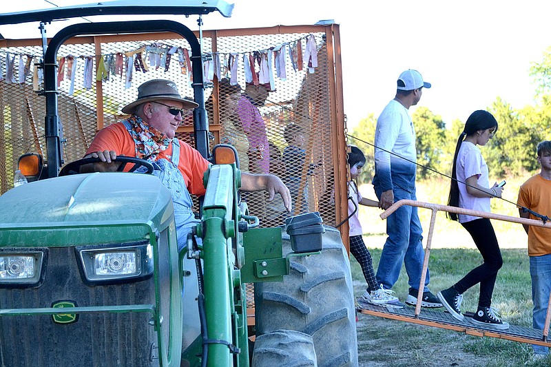 TIMES photographs by Annette Beard
Dennis 'Farmer' McGarrah drives the tractor for the hayrides at McGarrah Farms Pumpkin Patch, which opened Sept. 24 and will be open until Oct. 31. For more photographs, go to the PRT gallery at https://tnebc.nwaonline.com/photos/.