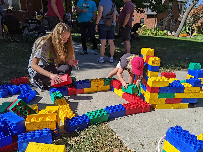 Ryan Pivoney/News Tribune
Neighbors Lillian Hussey, 13 (left), and June Pearson, 3 (right), assembled large blocks as live acoustic music filled the air Sunday at Porchfest in the Forest Hill neighborhood. Blocks was one of several activities the Jefferson City Parks, Recreation and Forestry Department provided for entertainment.