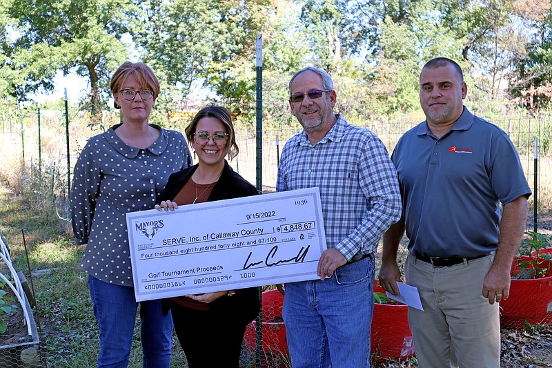 Fulton Mayor Lowe Cannell and Parks and Recreation Director Clay Caswell present a check of $4,848.67 for the 11th Annual Mayor's Cup to SERVE Executive Director Courtney Harrison and Outreach Coordinator Carol Lewis. (Submitted photo)