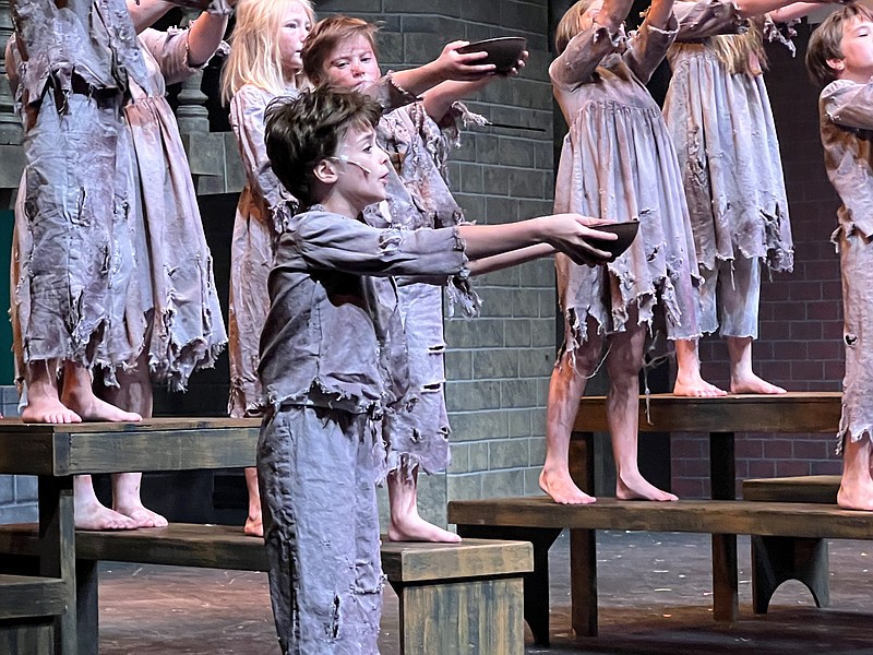 Hope Hinton (foreground) splits the title role with Jaydon Clark in “Oliver!” at Wildwood Park for the Arts. (Special to the Democrat-Gazette)