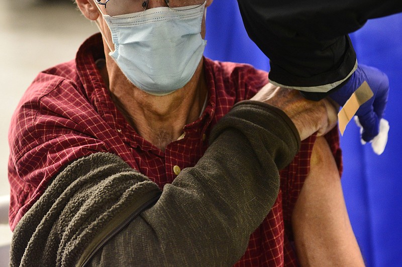 A man receives a flu shot Tuesday, Oct. 26, 2021, in Brattleboro, Vt.. Doctors have a message for vaccine-weary Americans: Don't skip your flu shot this fall 2022. And for the first time, seniors are urged to get a special extra-strength kind. (Kristopher Radder/The Brattleboro Reformer via AP, File)