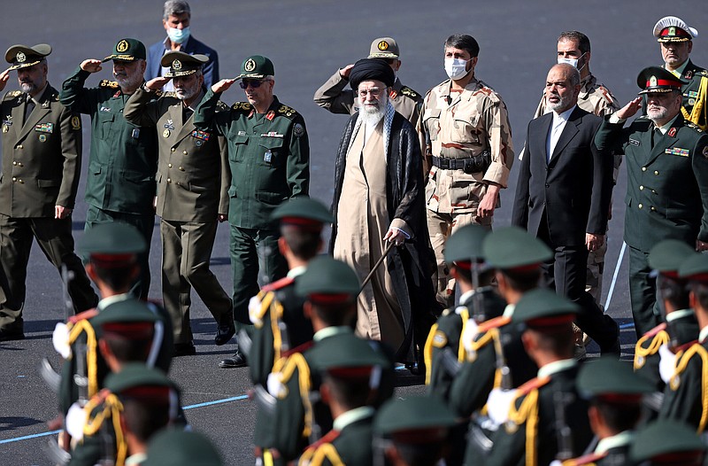 In this picture released by the official website of the office of the Iranian supreme leader, Supreme Leader Ayatollah Ali Khamenei, center, reviews a group of armed forces cadets during their graduation ceremony Monday, Oct. 3, 2022, at the police academy in Tehran, Iran. Khamenei responded publicly on Monday to the biggest protests in Iran in years, breaking weeks of silence to condemn what he called “rioting” and accuse the U.S. and Israel of planning the protests. (Office of the Iranian Supreme Leader via AP)