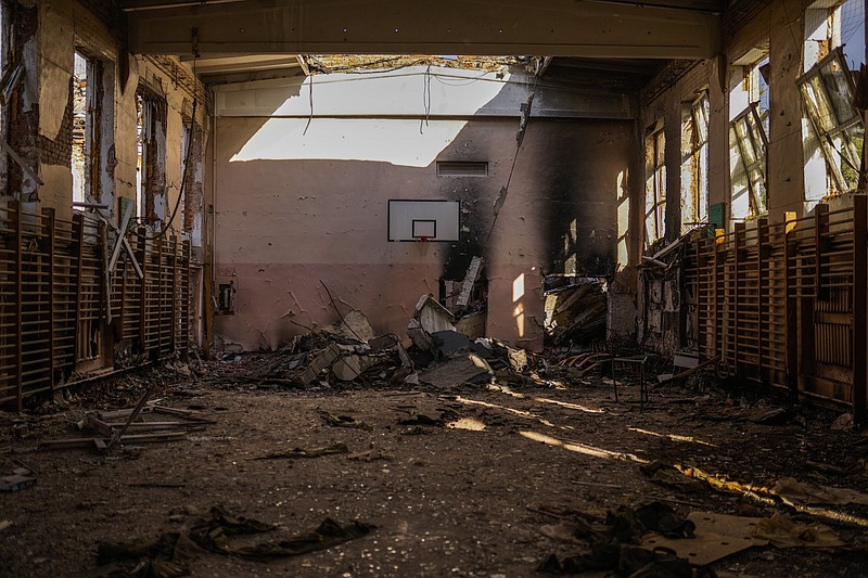 Debris is scattered at the indoor sport pavilion of a destroyed school in Izium, Ukraine, Monday, Oct. 3, 2022. (AP Photo/Francisco Seco)