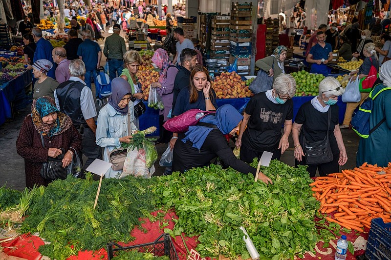 Customers shop at a food market in the Kadikoy district of Istanbul. MUST CREDIT: Bloomberg photo by Erhan Demirtas.