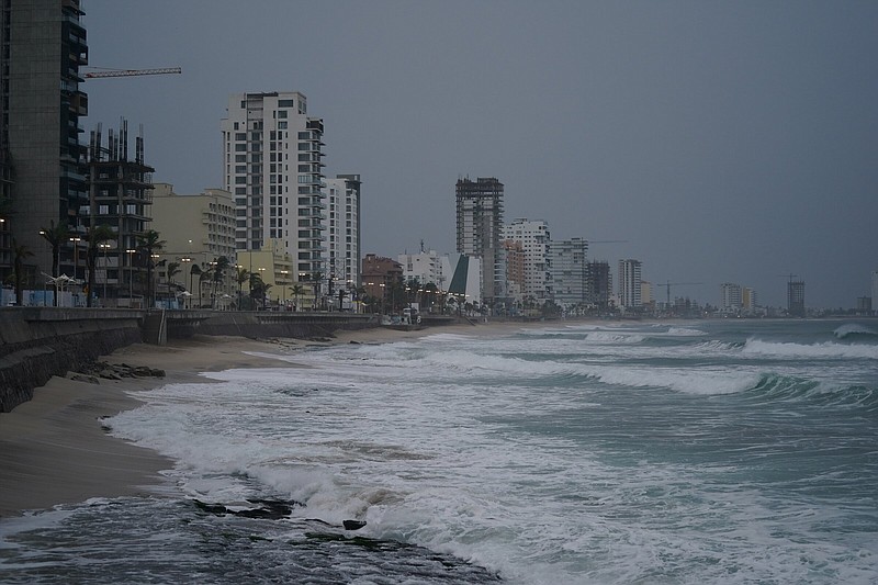 Skies are dark along the coast of Mazatlan, Mexico, early Monday, Oct. 3, 2022, as Hurricane Orlene approaches. The storm is heading for Mexico's northwest Pacific coast between Mazatlan and San Blas. (AP Photo/Fernando Llano)