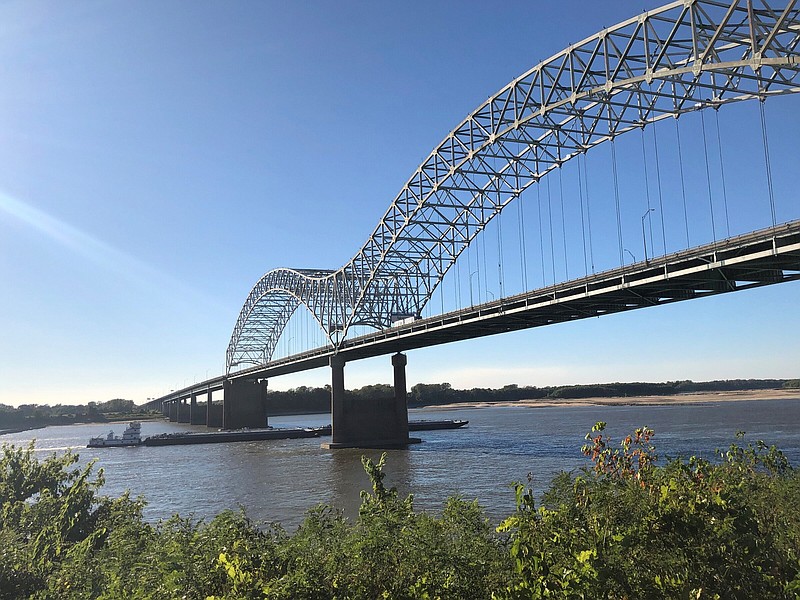 A barge moves north on the Mississippi River under the Interstate 40 bridge connecting Tennessee and Arkansas on Thursday, Sept. 29, 2022, in Memphis, Tenn. (AP Photo/Adrian Sainz)