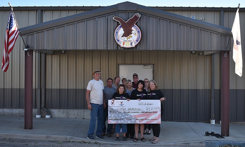 Democrat photo/Garrett Fuller — The California Fraternal Order of Eagles (FOE) presented a check Monday to Karen's Tribe at the California FOE building. Karen's Tribe is a group of friends raising funds for Karen Dameron, a community member who recently received a stem cell transplant for her battle against Hodgkin's lymphoma. Karen's Tribe previously hosted the "Karen's Tribe: Funding the Fight" fundraiser at the California FOE building. Pictured are, from left, in the front row: California FOE President Steve Liebi, Tammy Bleich, Karen Phillips and Tracy Upschulte; second row: Greg Buschjost, Shelly Hampton and Lana Nelson; back row: Rick Smith, Connie Smith and Craig Nelson.