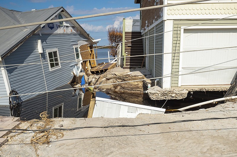 Battered and flooded residences are shown after Hurricane Ian leaves behind widespread damage across Pine Island, Fla., on Tuesday, Oct. 4, 2022. (Scott Clause/The News-Press via AP)