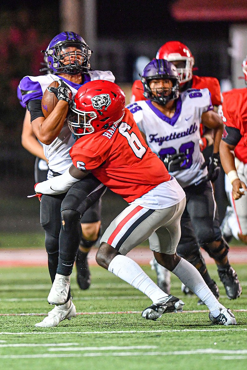 Fort Smith Northside defender Josh Hardwick (6) tries to bring Fayetteville running back J.J. Harjo down on Friday, Sept. 9, 2022 at Mayo-Thompson Stadium in Fort Smith. The Grizzlies will host Jonesboro this week in a 7A-Central clash.
(NWA Democrat-Gazette/Hank Layton)