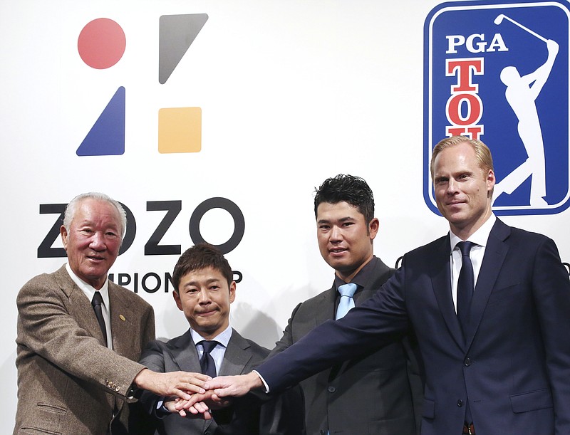 FILE - From left, Japan Golf Tour Organization President Isao Aoki, ZOZO Inc. President Yusaku Maezawa, PGA Tour Player Hideki Matsuyama and PGA Tour Vice President Christian Hardy join their hands while posing for a photo during a press conference in Tokyo, Tuesday, Nov. 20, 2018. The PGA Tour and European tour have a joint operating venture for the next 13 years. Now it appears they want the Japan Golf Tour to join them. (AP Photo/Koji Sasahara, File)